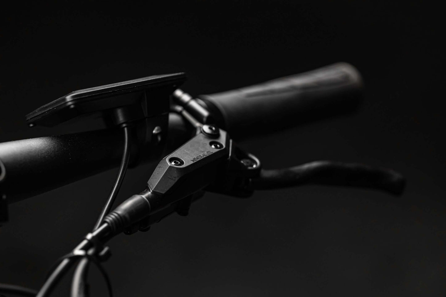 Close-up of Rambo Bikes RANGER eBike handlebar showing control panel and grips on black background.