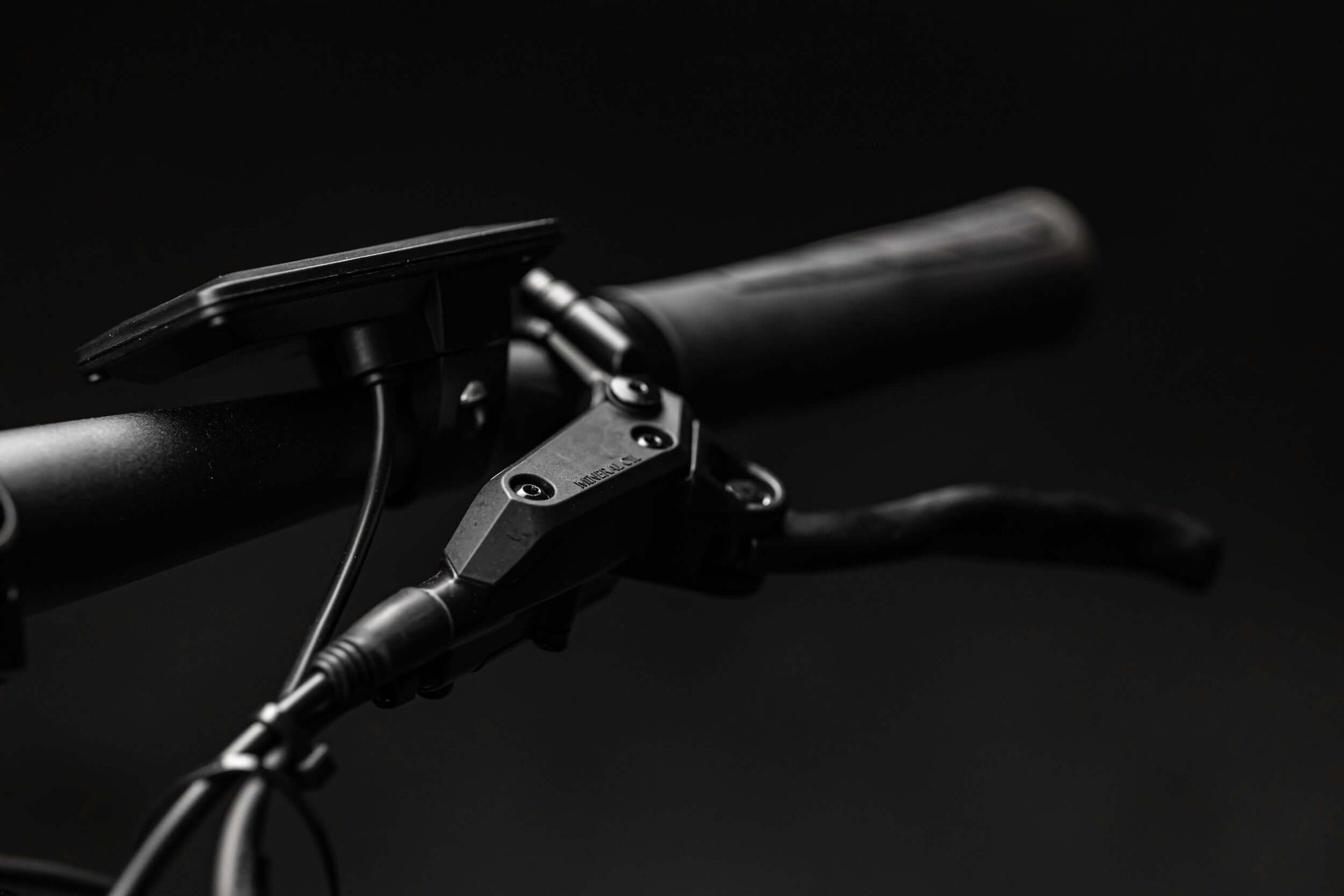 Close-up of Rambo Bikes RANGER eBike handlebar showing control panel and grips on black background.