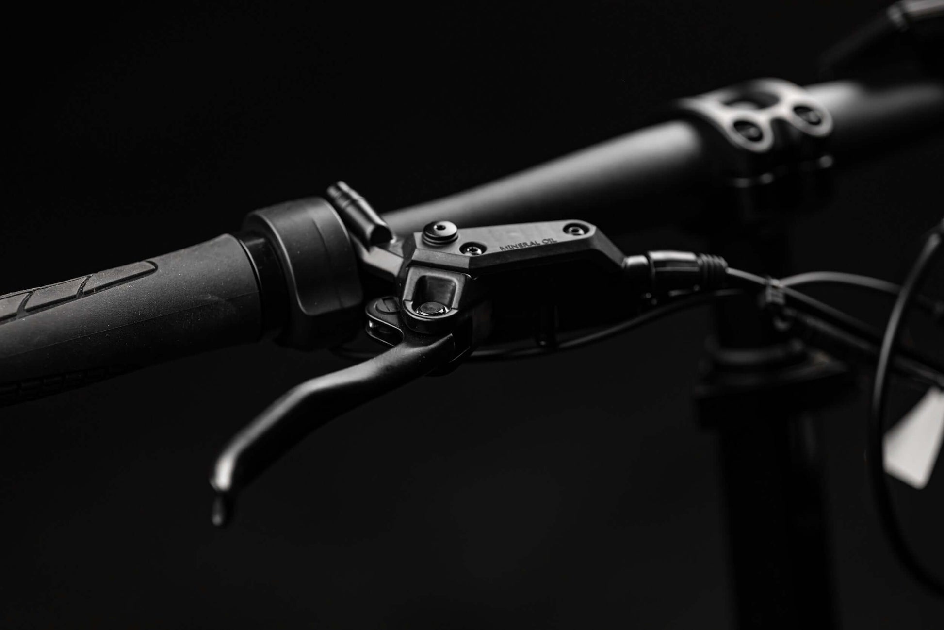 Close-up of the Rambo Bikes RANGER eBike handlebar with brake lever and grip, showcasing rugged design.