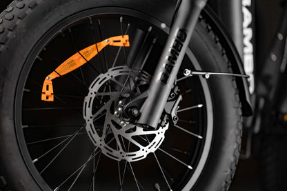 Close-up of Rambo Bikes RANGER folding eBike front wheel with fat tire and disc brake.