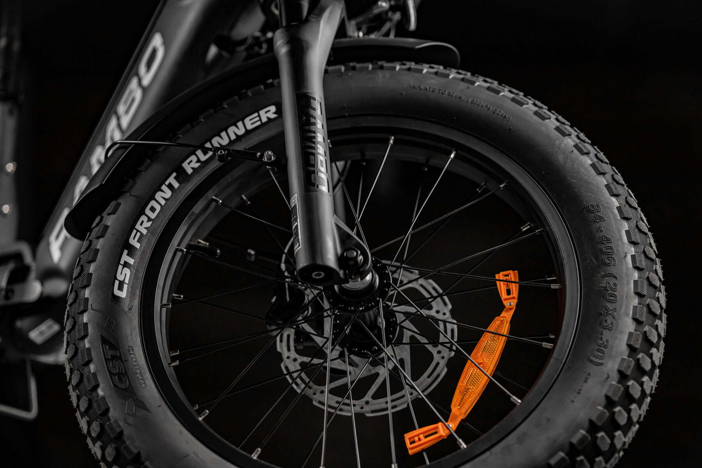 Close-up of Rambo Bikes RANGER folding eBike tire showing rugged tread and vibrant orange details.