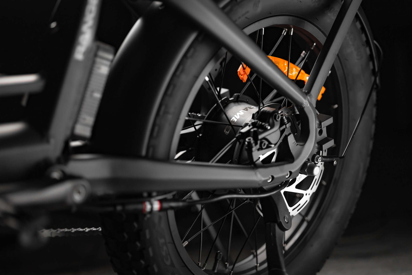 Close-up of Rambo Bikes RANGER Folding eBike rear wheel, showcasing fat tire and brake components for robust performance.