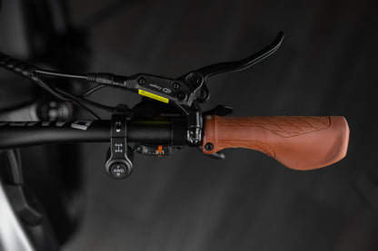 Close-up of Rambo Bike Hellcat 2.0 AWD Electric Bikes right handlebar with brake lever, gear shifter and al wheel drive controls on a black background