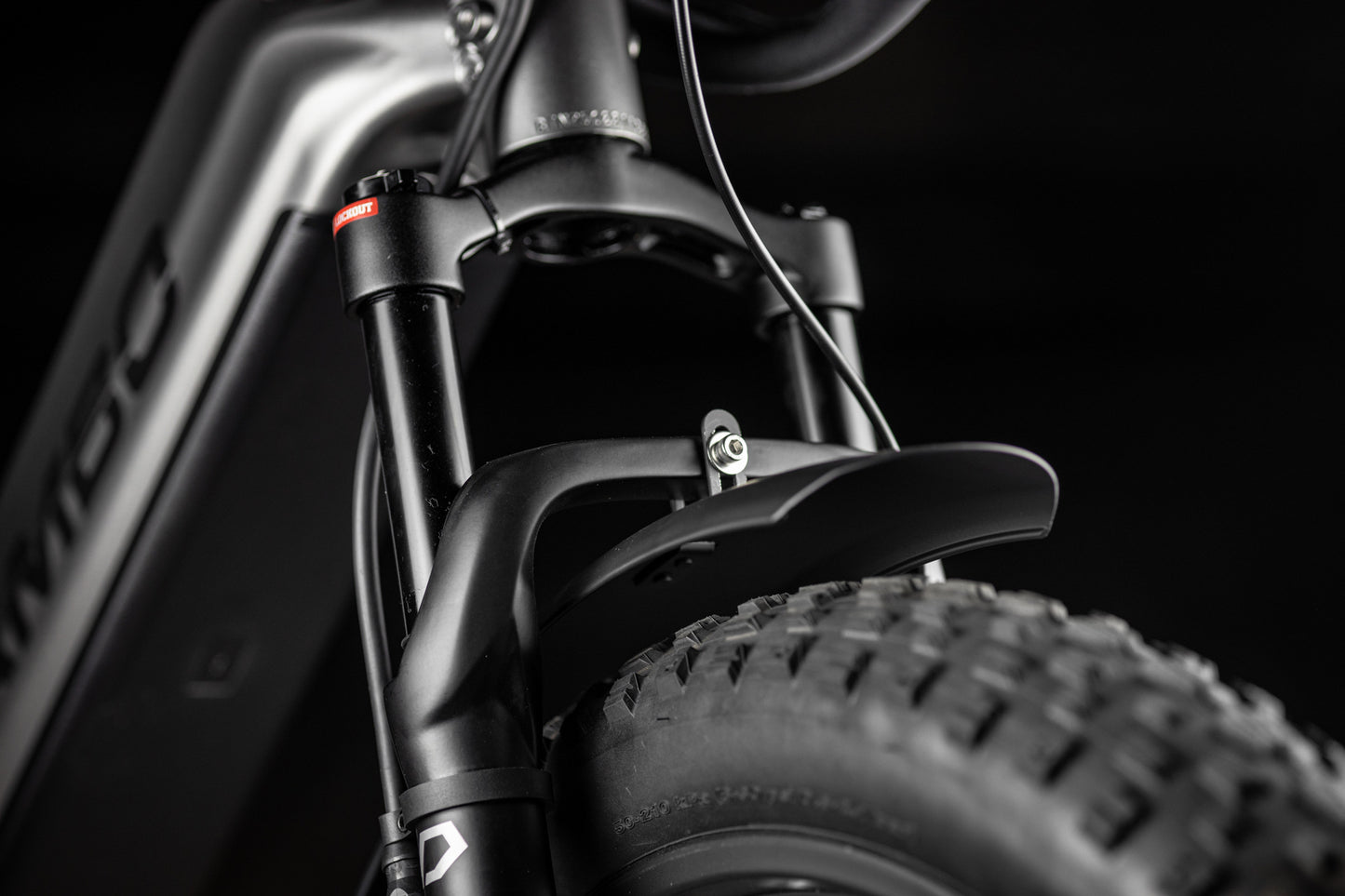 Close-up of Rambo Bike Hellcat 2.0 AWD Electric Bikes front suspension fork on a black background