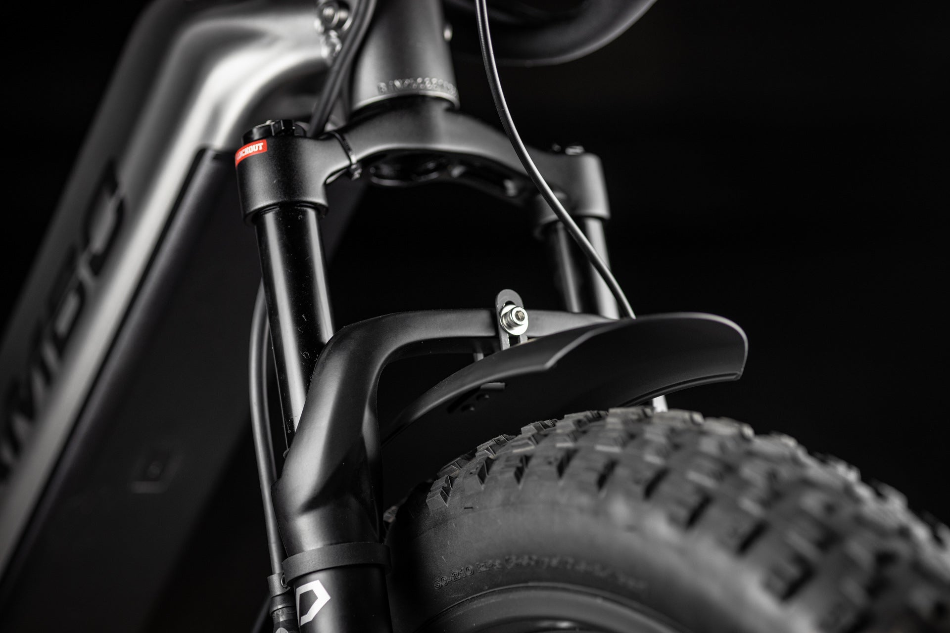Close-up of Rambo Bike Hellcat 2.0 AWD Electric Bikes front suspension fork on a black background