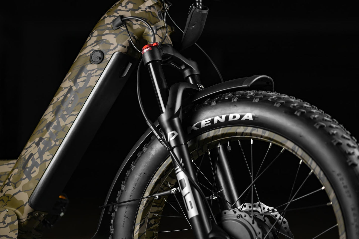 Close-up of Rambo Bikes Krusader 3.0 All-wheel drive Electric Bikes front suspension forks and front wheel on black background