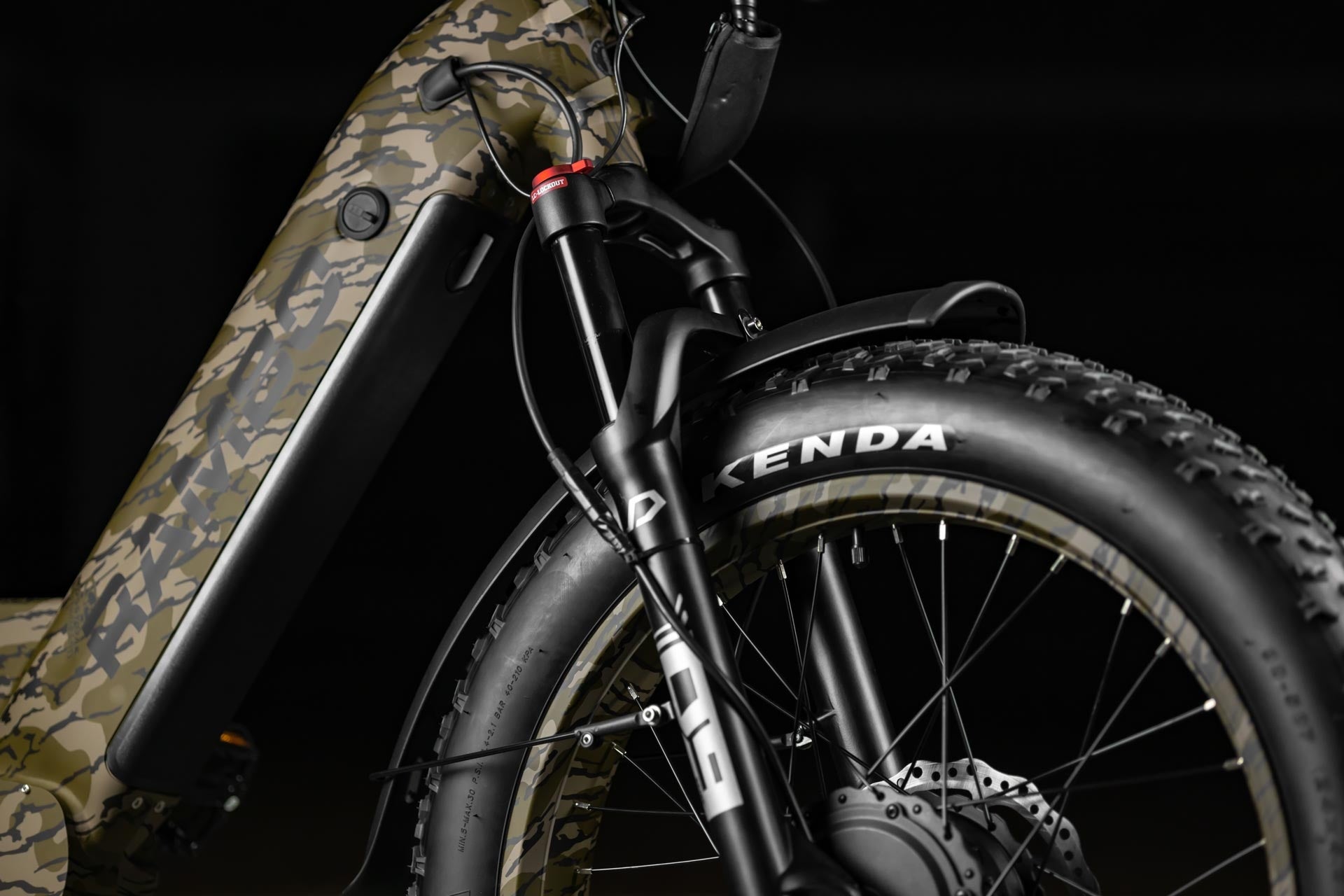 Close-up of Rambo Bikes Krusader 3.0 All-wheel drive Electric Bikes front suspension forks and front wheel on black background