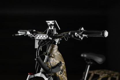 Close-up of Rambo Bikes Krusader 3.0 All-wheel drive Electric Bikes handlebars and headlight on black background