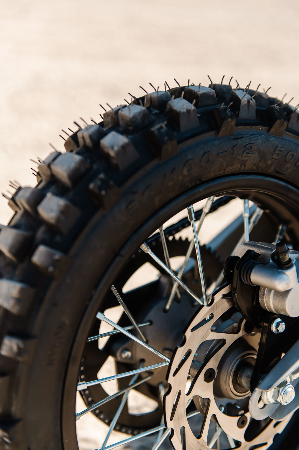 Close up of a rear wheel of Drift Hero USA 2500W Electric Dirt Bike