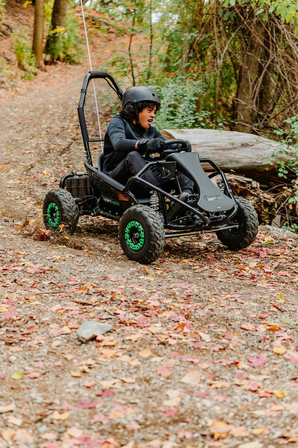 Child driving a Drift Hero USA 1 Seater Electric Go-kart on a forest path