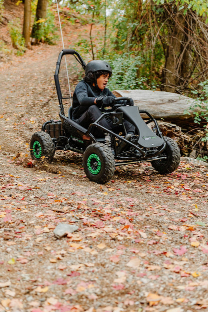 Child driving a Drift Hero USA 1 Seater Electric Go-kart on a forest path