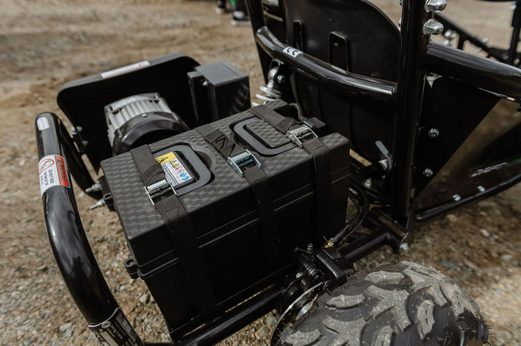 Close-up of a black toolbox attached to a Drift Hero USA 1 Seater Electric Go-kart on a rough terrain