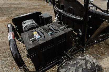 Close-up of a black toolbox attached to a Drift Hero USA 1 Seater Electric Go-kart on a rough terrain