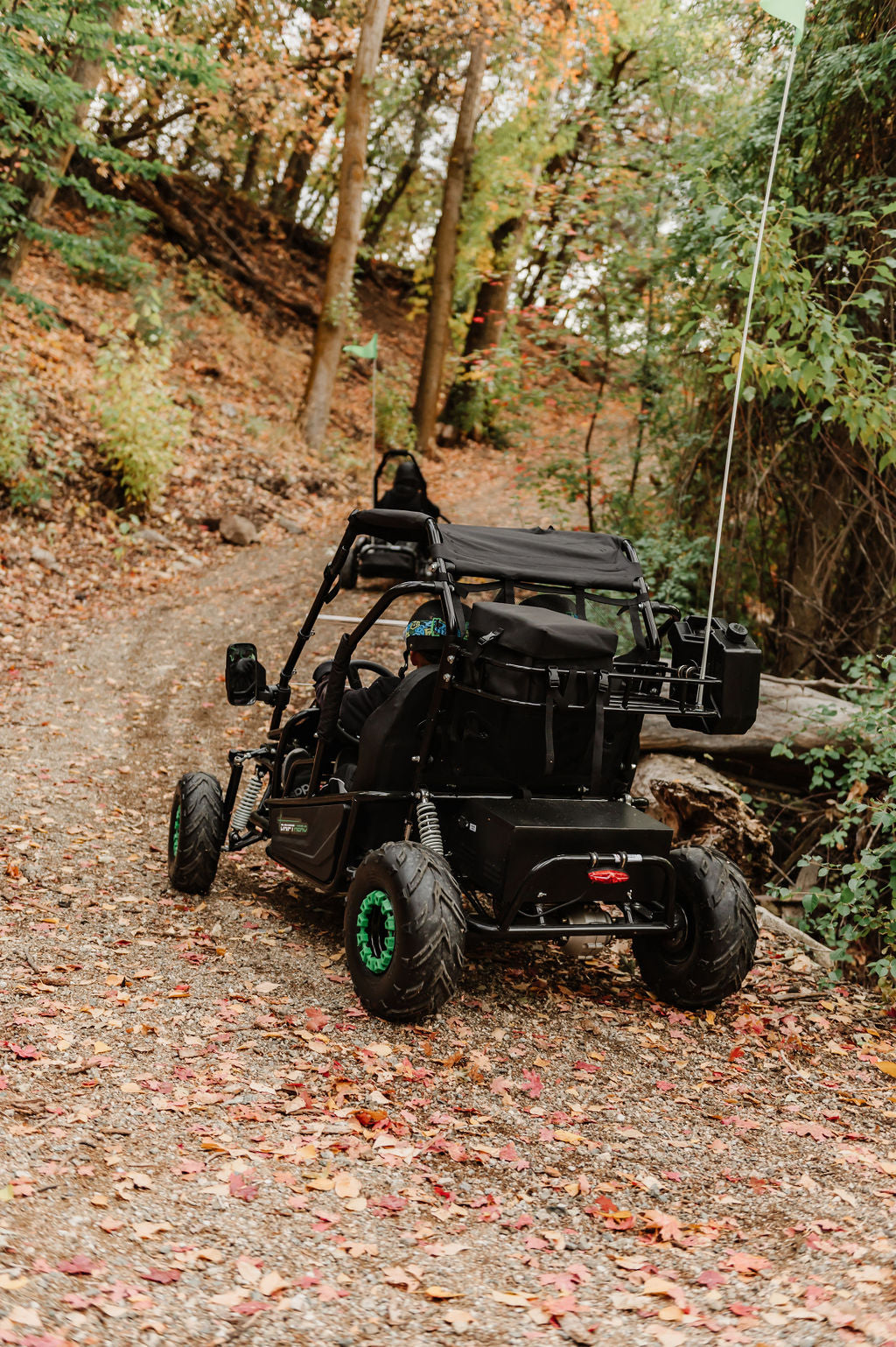 Drift Hero USA 2 Seater Electric Go-kart  on a forest trail with trees and foliage around.