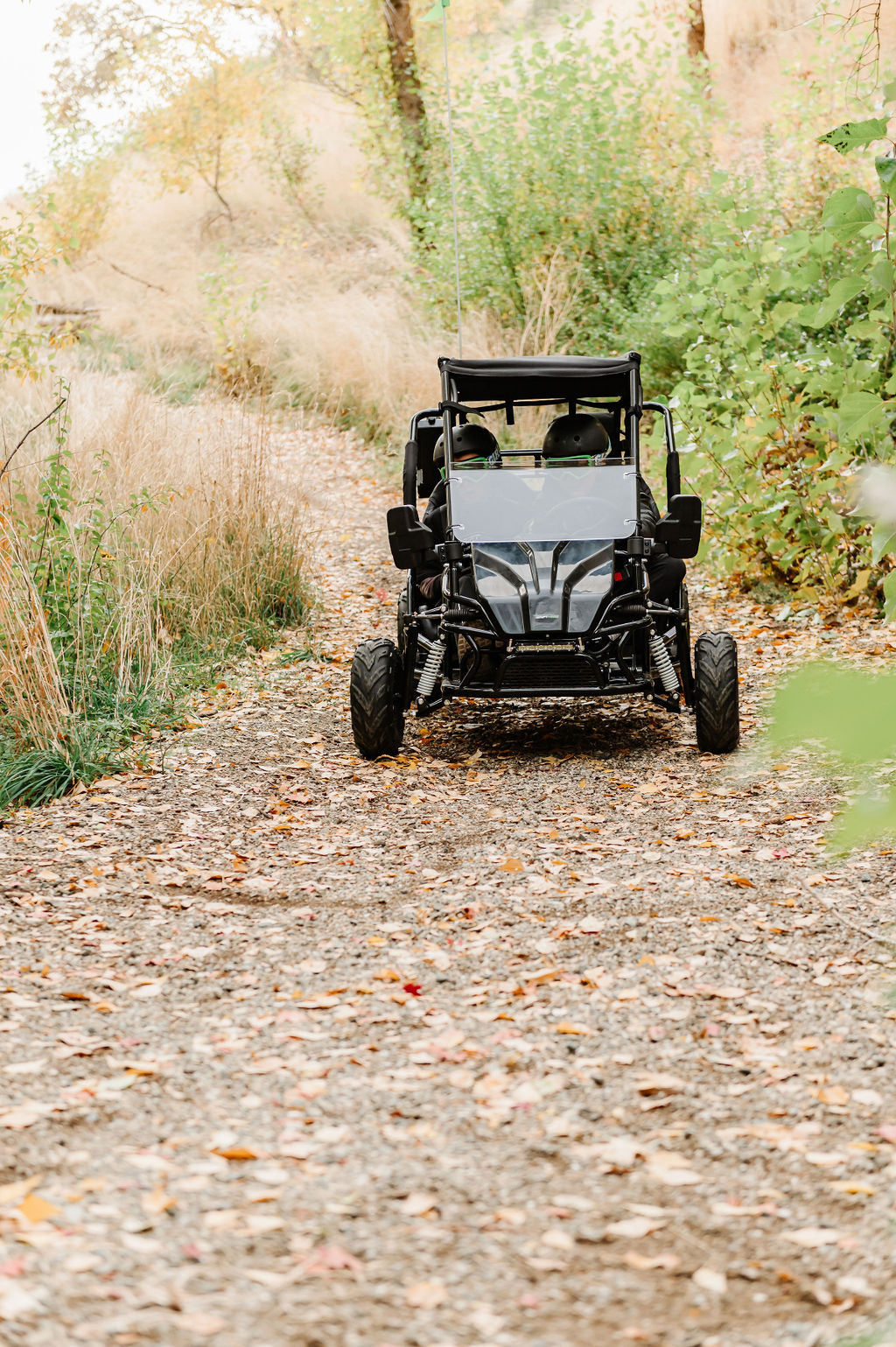 Drift Hero USA 2 Seater Electric Go-kart  on a dirt path surrounded by nature