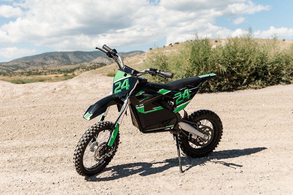 Drift Hero USA 2500W Electric Dirt Bike with number 24 on a dirt road with mountains in the background