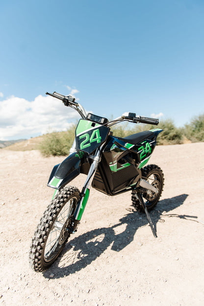 Drift Hero USA 2500W Electric Dirt Bike with number 24 on a gravel surface with a blue sky background