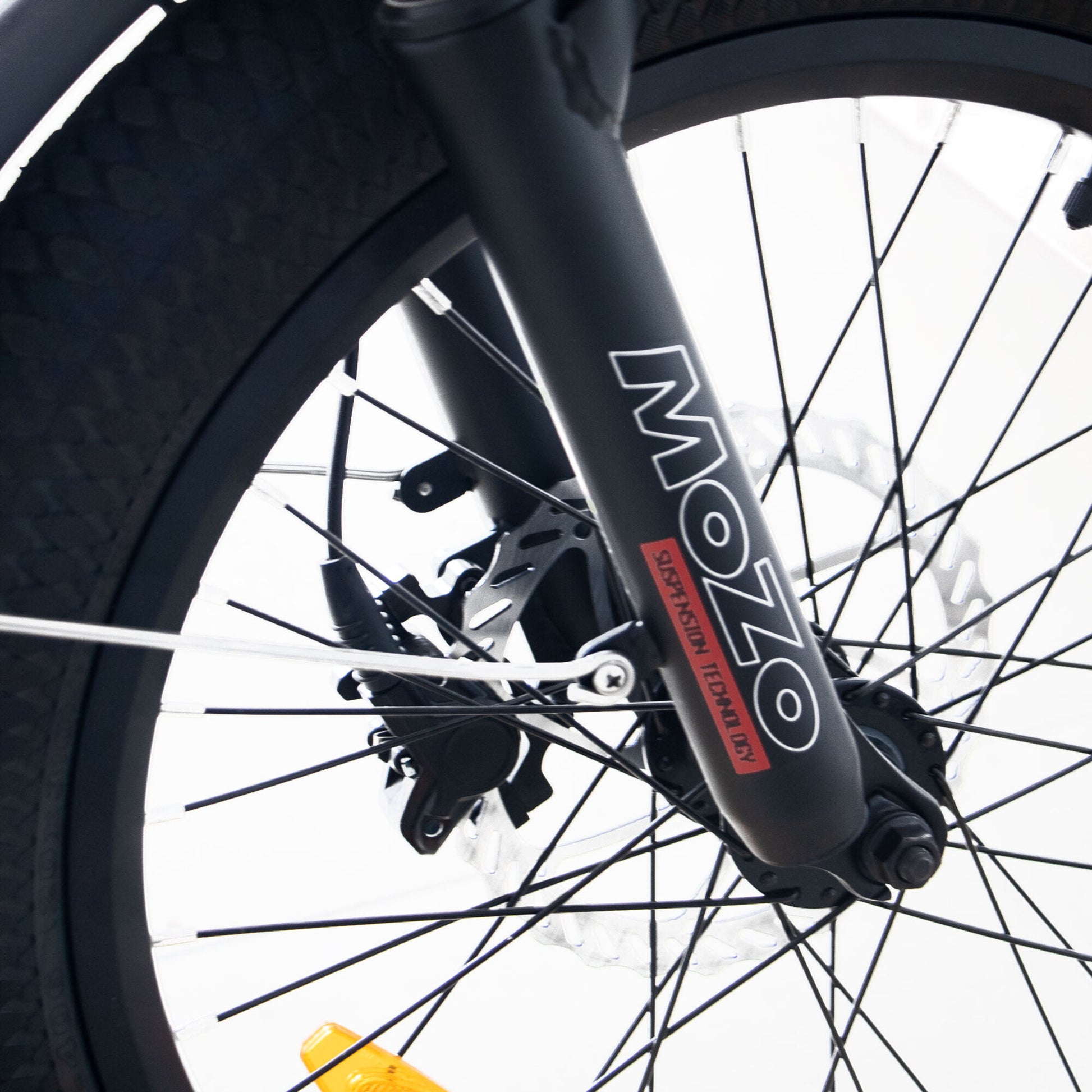 Close-up of a Eunorau G30 Cargo electric bike wheel with 'MOZO' branding on the suspension fork.