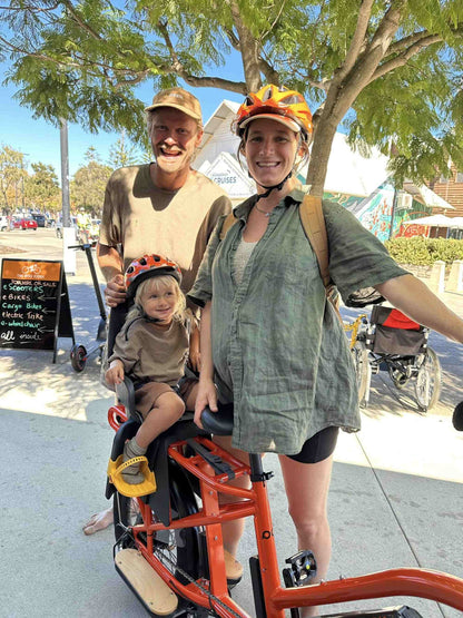 Family with a child on a tandem Eunorau G30 Cargo electric bike in an urban setting