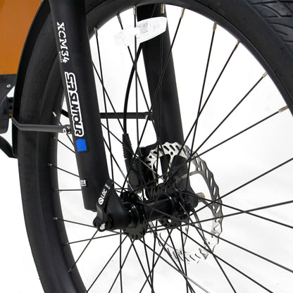Eunorau Meta 275 1.0 Electric Bike Close-up of a frontwheel with suspension fork and hydraulic brakes on a white background