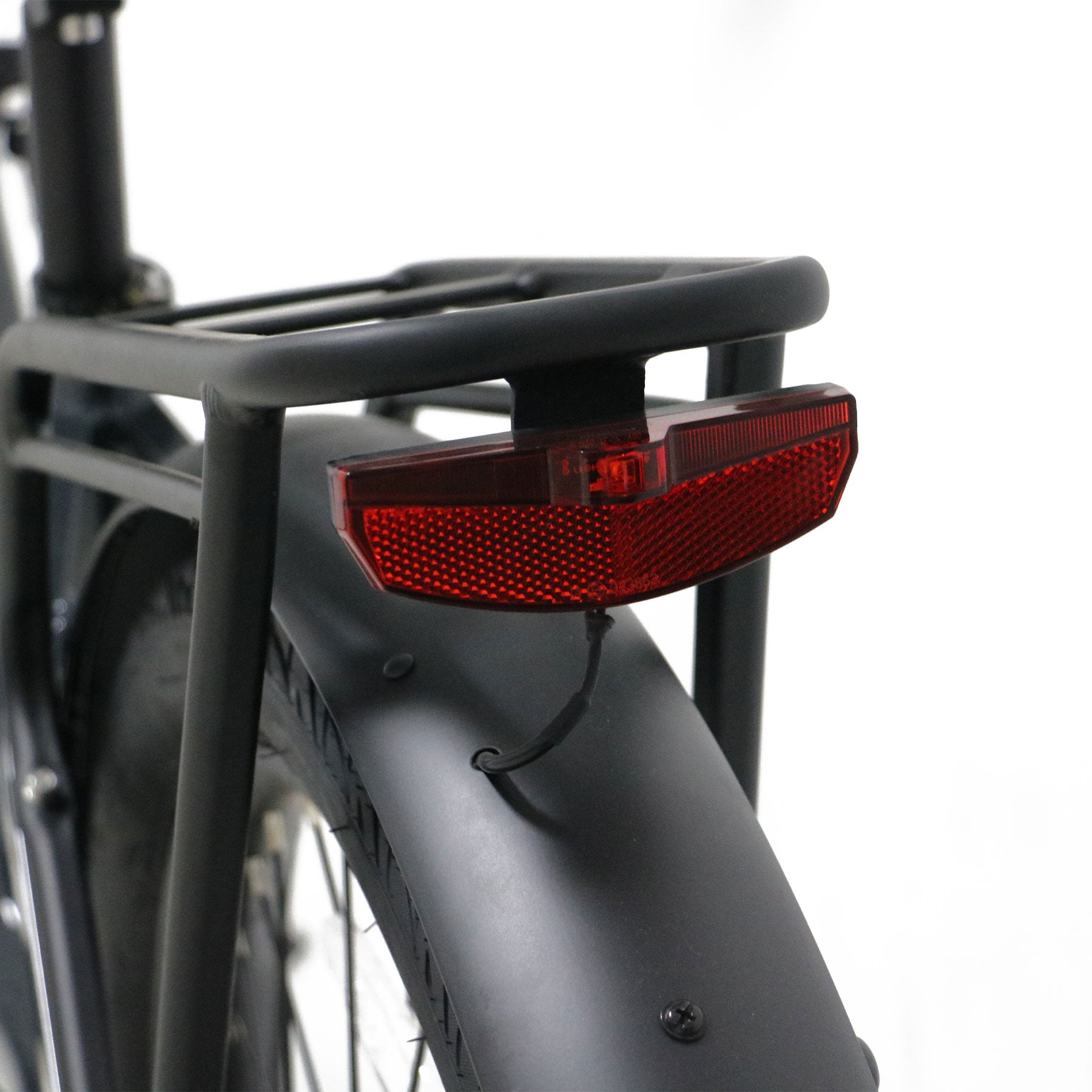 Eunorau Meta 275 1.0 Electric Bike Close up of red reflector attached to a black bike rack on a white background