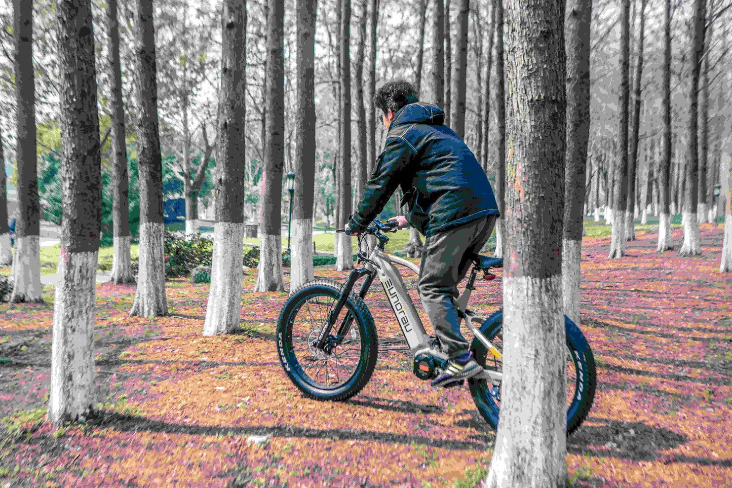 EUNORAU Specter-S 3.0 electric bike ridden on a forest trail, demonstrating off-road capability
