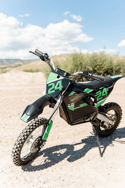 Green and Drift Hero USA 2500W Electric Dirt Bike with number 24 on a dirt road under a blue sky.