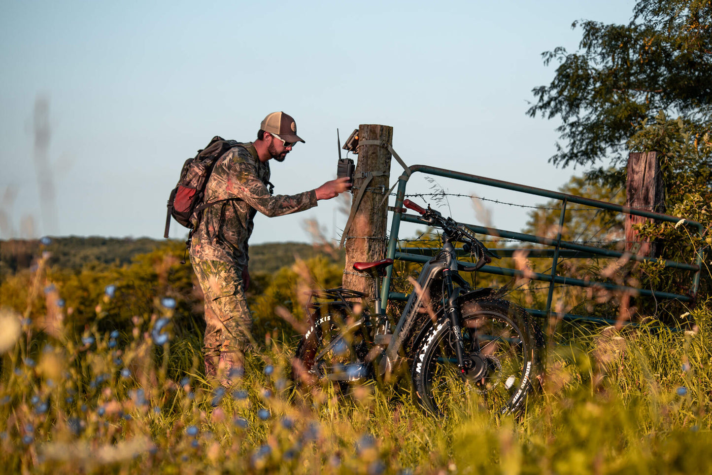 Hunter in a camouflage on a Rambo Bike Hellcat 2.0 AWD Electric Bike in the field.