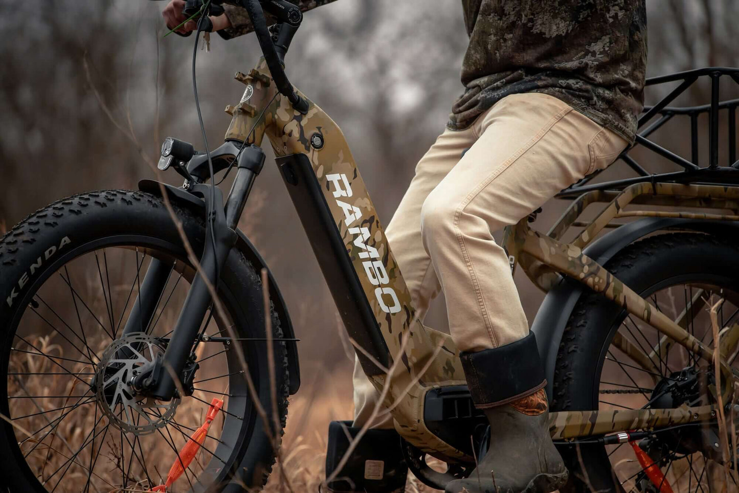 Person riding a Rambo Bikes SAVAGE 2.0 Electric Bike in a natural setting