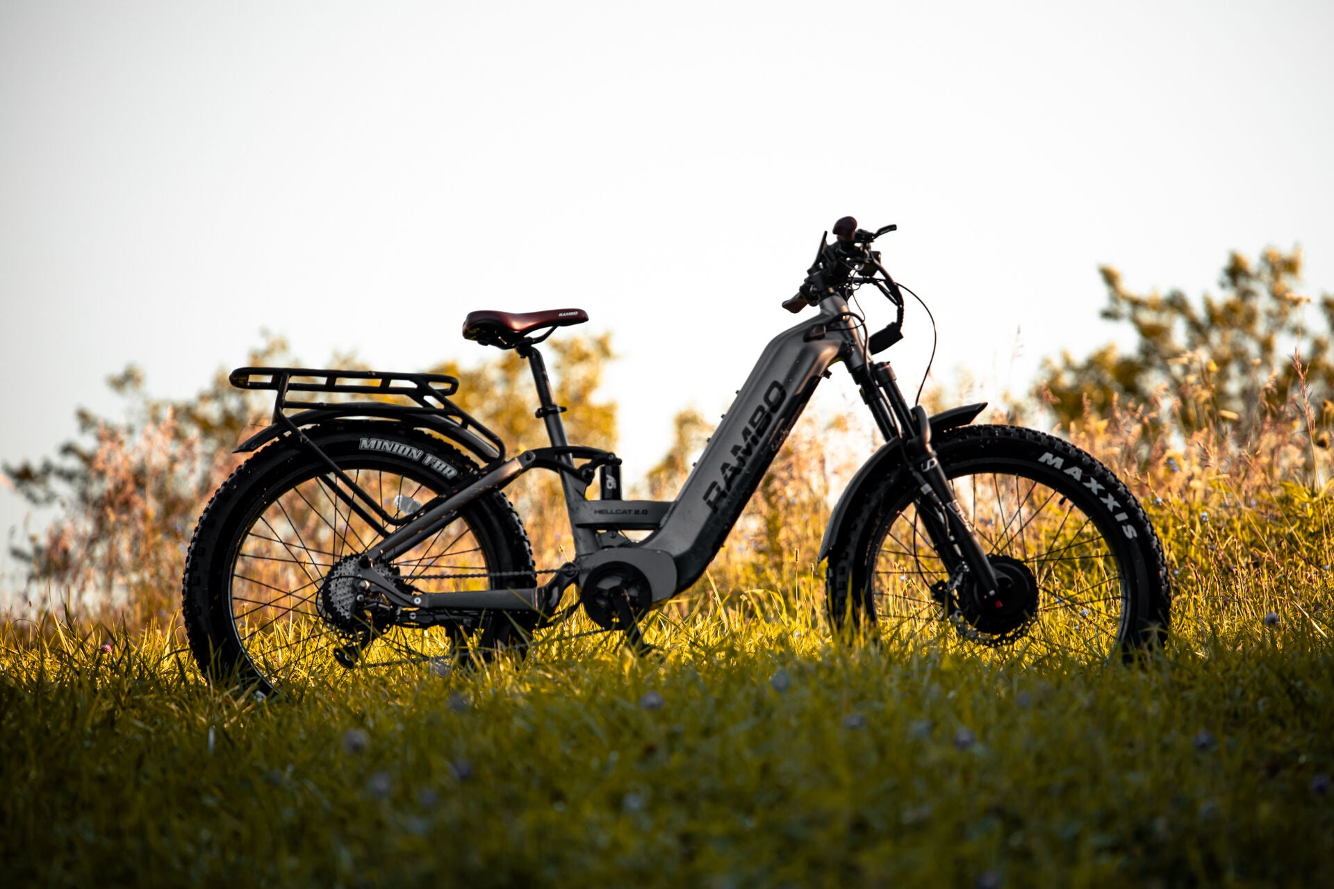 Rambo Bike Hellcat 2.0 AWD Electric Bike in a grassy field with a blurred background