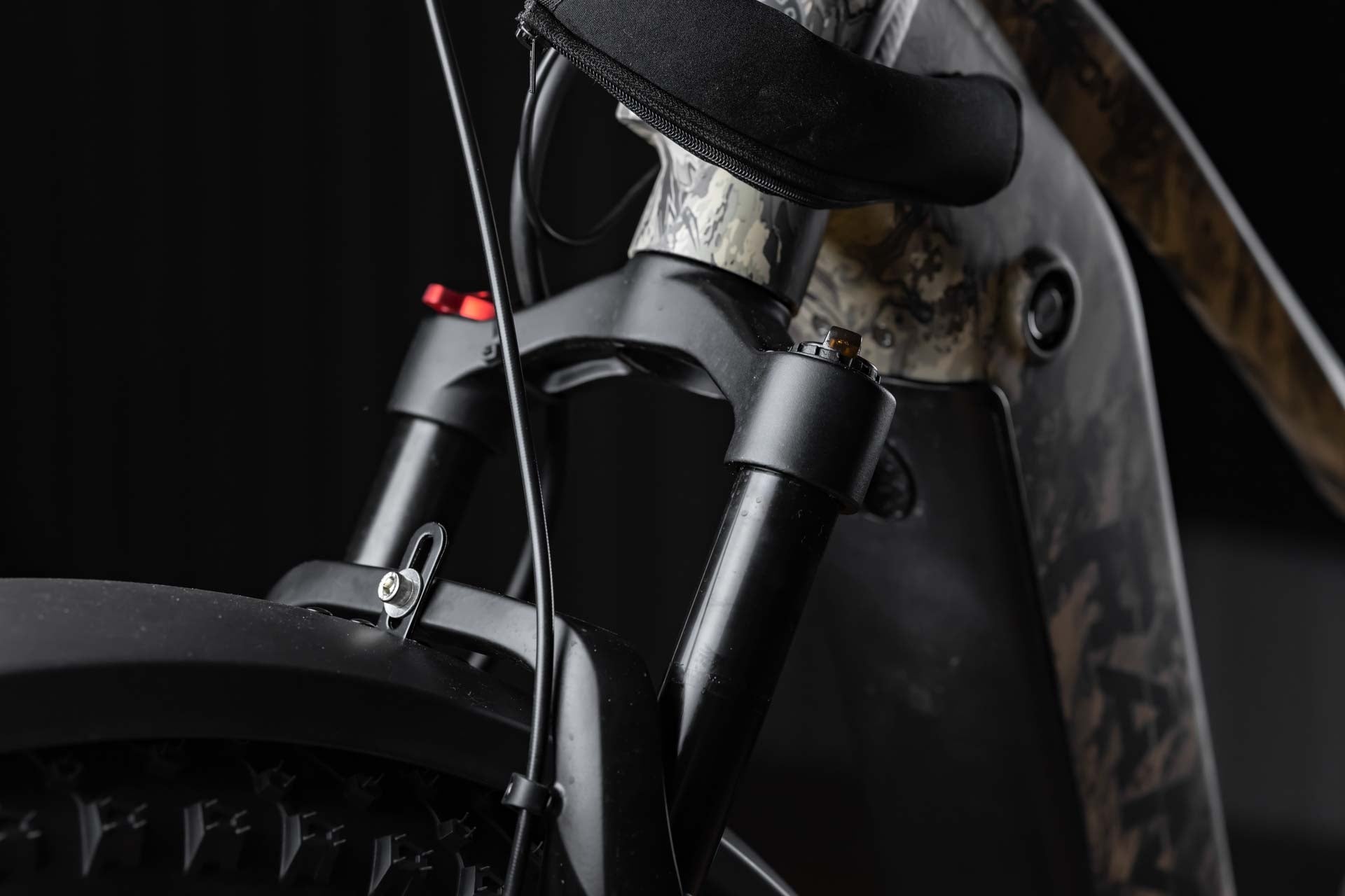Close-up of a Rambo Bike Megatron 4.0 AWD Electric bike front suspension system with a dark background