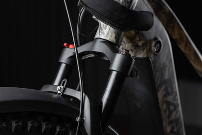 Close-up of a Rambo Bike Megatron 4.0 AWD Electric bike front suspension system with a dark background