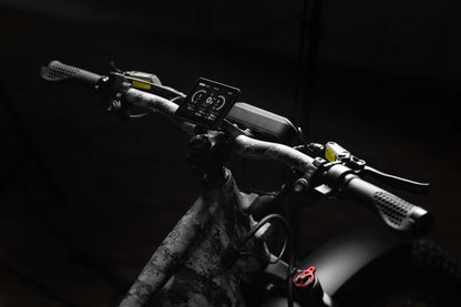 Close-up of a Rambo Bike Megatron 4.0 AWD Electric bike handlebar with digital display against a dark background