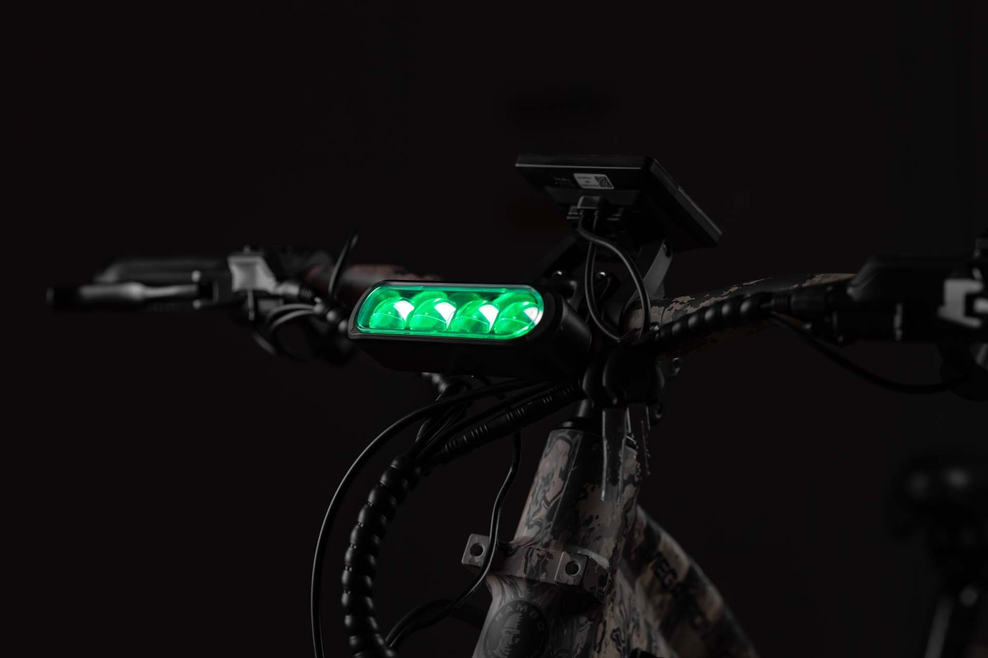 Rambo Bike Megatron 4.0 AWD Electric bike with a green light on the handlebar against a dark background
