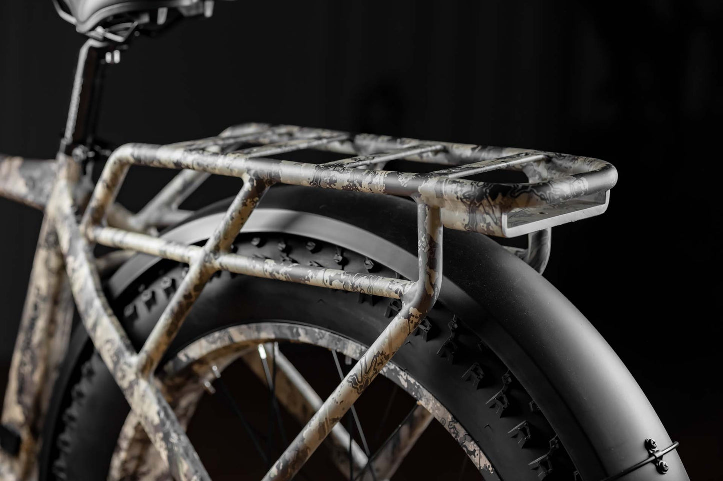 Close-up of Rambo Bike Megatron 4.0 AWD Electric bikes rear rack on black background