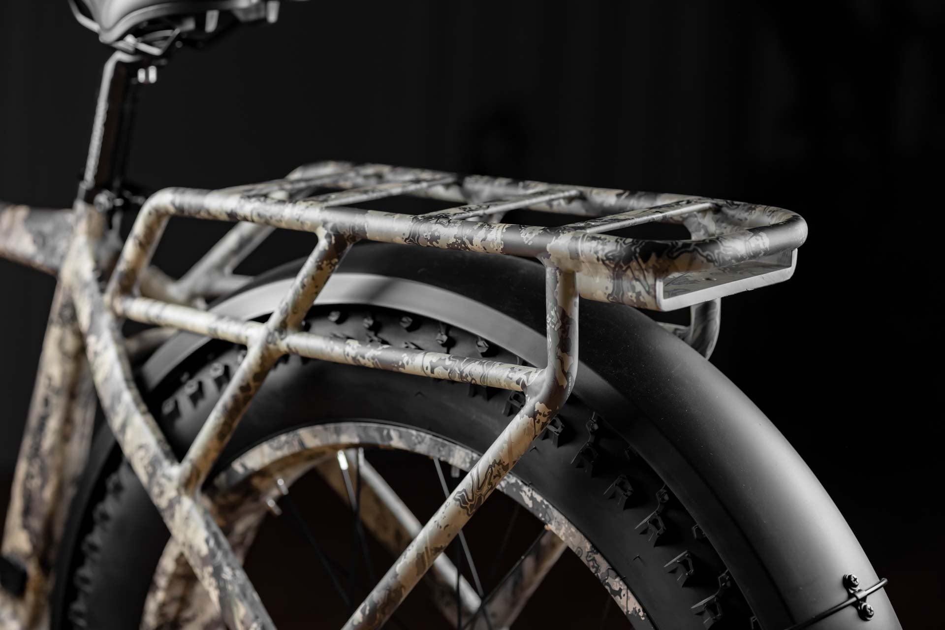 Close-up of Rambo Bike Megatron 4.0 AWD Electric bikes rear rack on black background