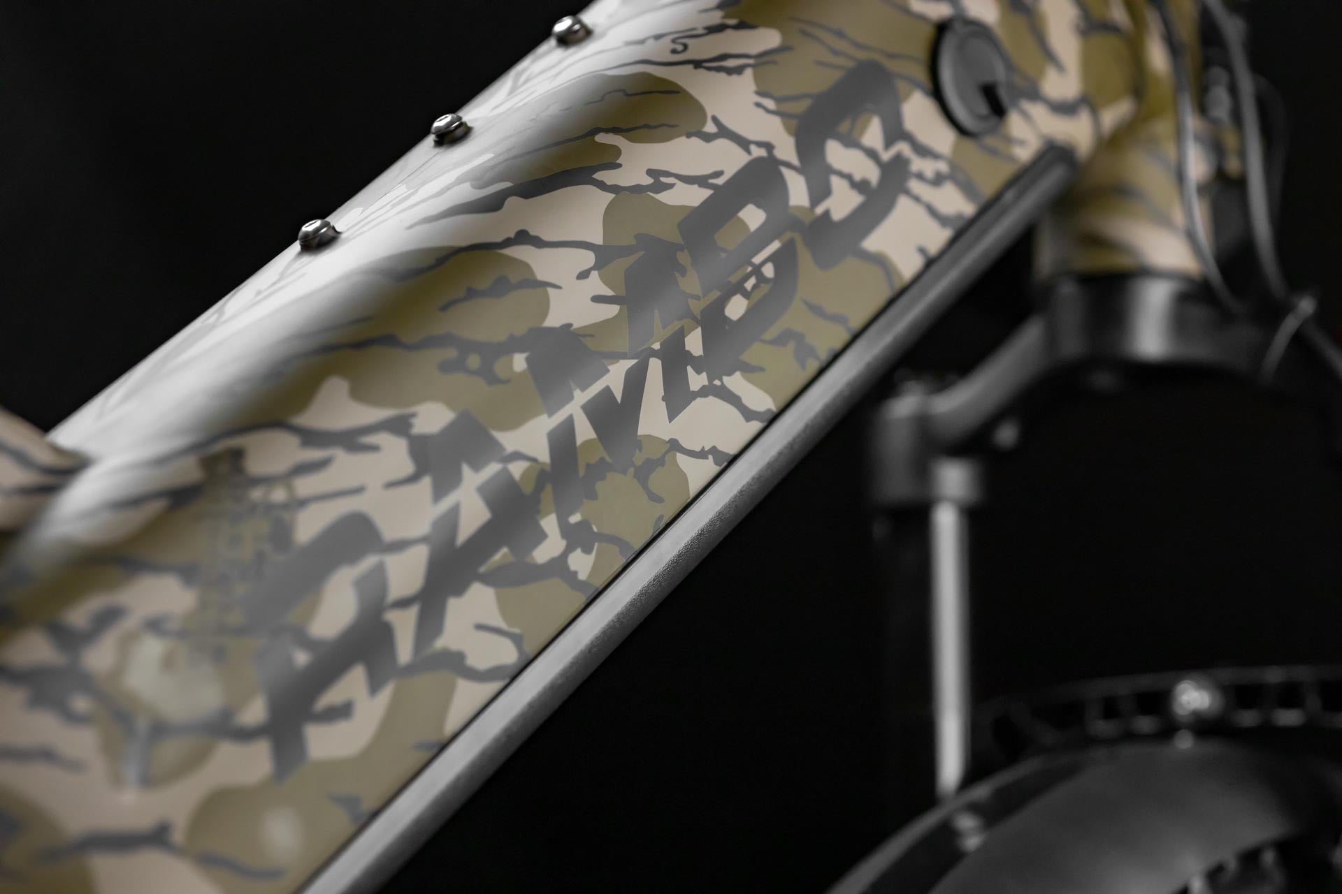 Close-up of Rambo Bikes Krusader 3.0 All-wheel drive Electric Bikes frame and logo on black background