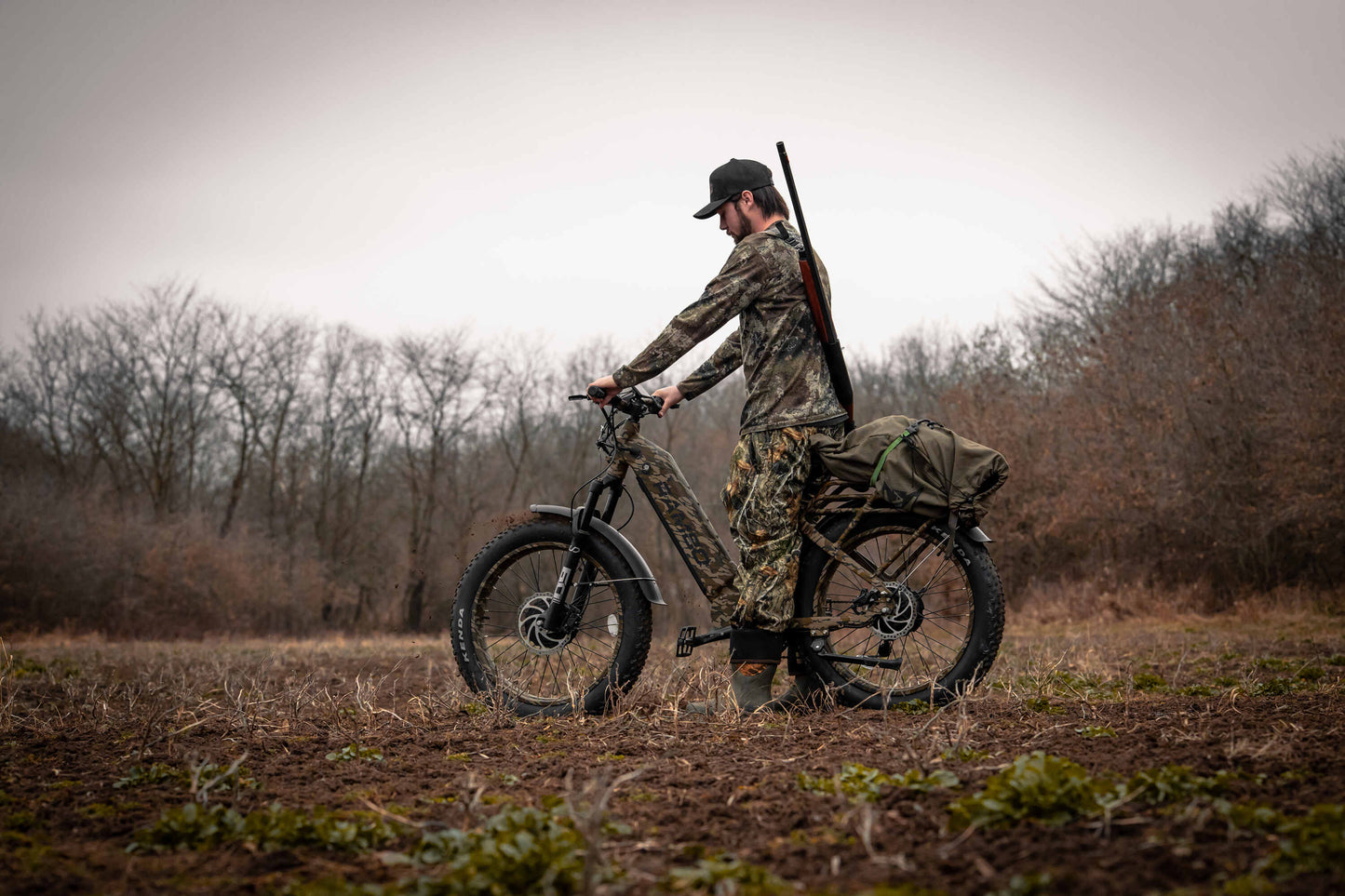 Hunter in the forest riding a Rambo Bikes Krusader 3.0 All-wheel drive Electric Bike with trees in the background