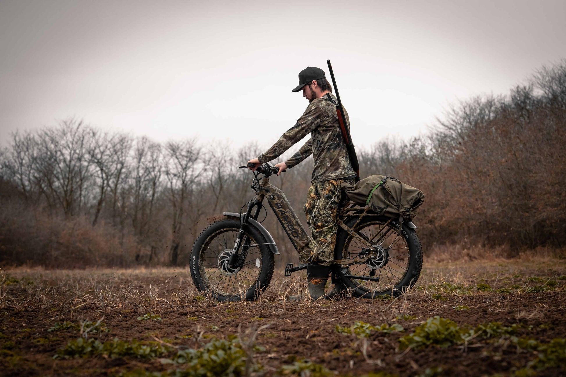 Hunter in the forest riding a Rambo Bikes Krusader 3.0 All-wheel drive Electric Bike with trees in the background