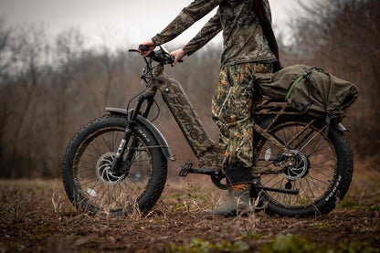 Hunter on dirt trail riding a full gear Rambo Bikes Krusader 3.0 All-wheel drive Electric Bike with trees in the background