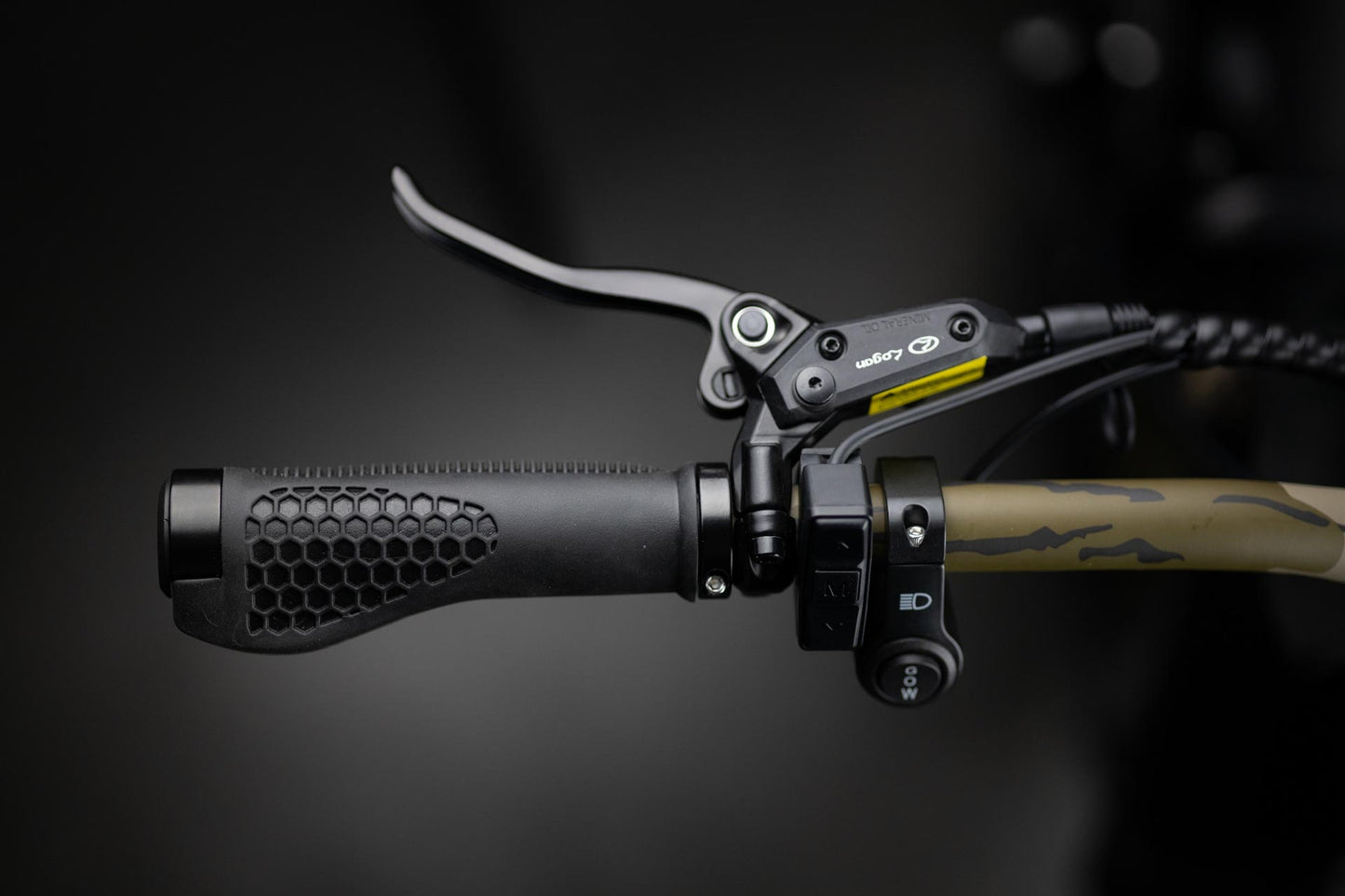 Close-up of Rambo Bikes Krusader 3.0 All-wheel drive Electric Bikes left handlebar with headlight controls, brake lever and throttle controls