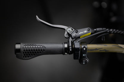 Close-up of Rambo Bikes Krusader 3.0 All-wheel drive Electric Bikes left handlebar with headlight controls, brake lever and throttle controls