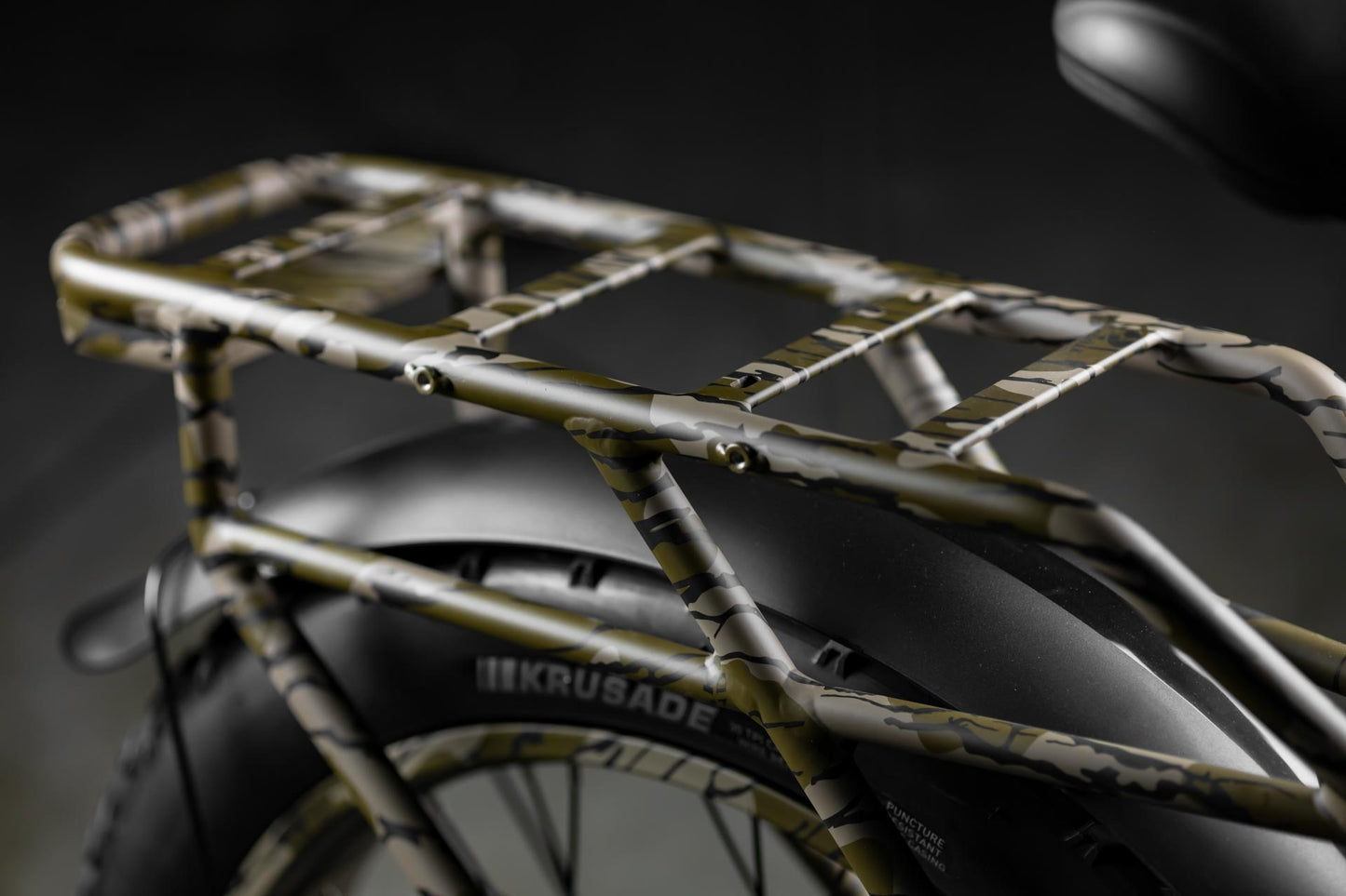 Close-up of Rambo Bikes Krusader 3.0 All-wheel drive Electric Bikes rear rack on black background