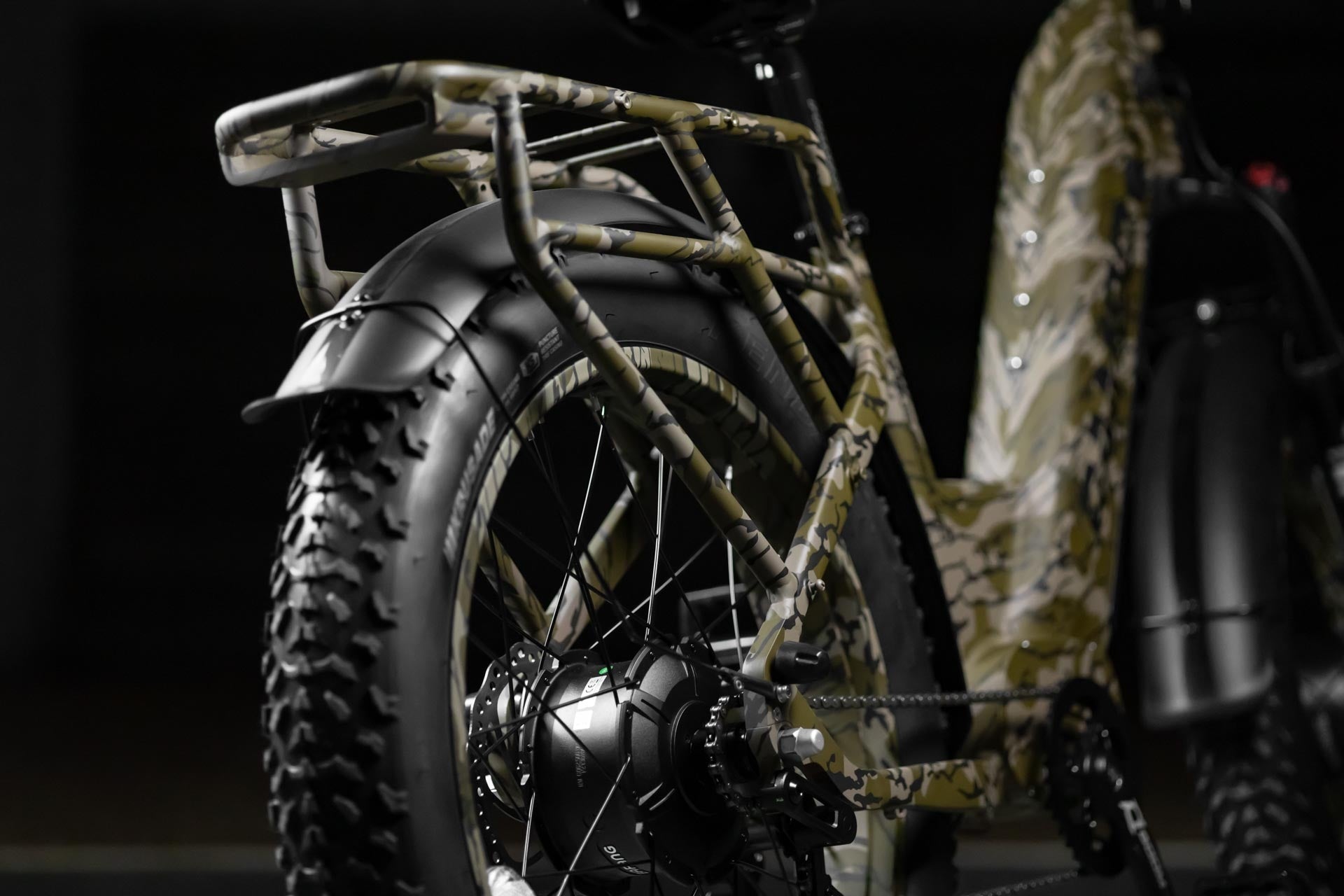 Close-up of Rambo Bikes Krusader 3.0 All-wheel drive Electric Bikes rear rack and rear wheel on black background