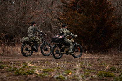 Two hunters in the forest riding a Rambo Bikes Krusader 3.0 All-wheel drive Electric Bike with trees in the background