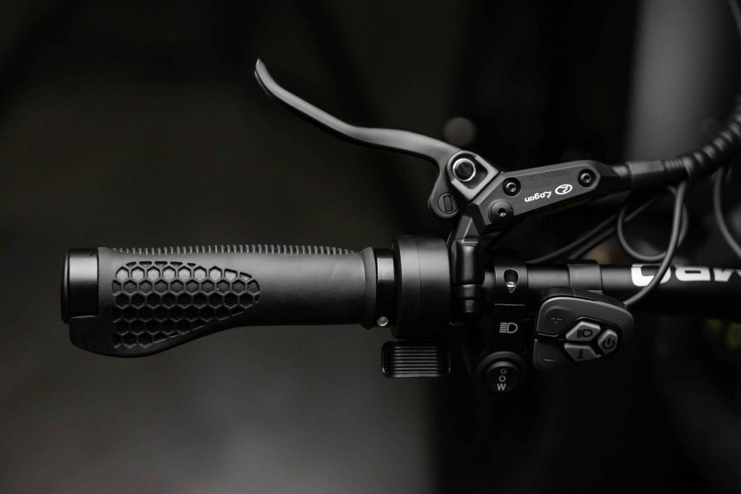 Close-up of a Rambo Bikes REBEL 2.0 Electric Bike left handlebar with brake lever, headlight controls and drive controls