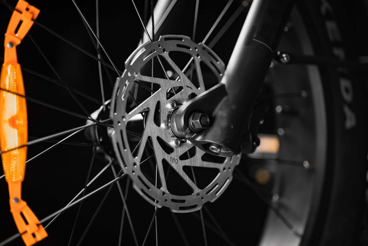 Close-up of Rambo Bikes SAVAGE 2.0 Electric Bikes front brakes system on dark background