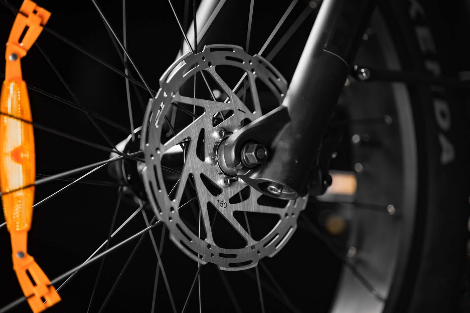 Close-up of Rambo Bikes SAVAGE 2.0 Electric Bikes front brakes system on dark background