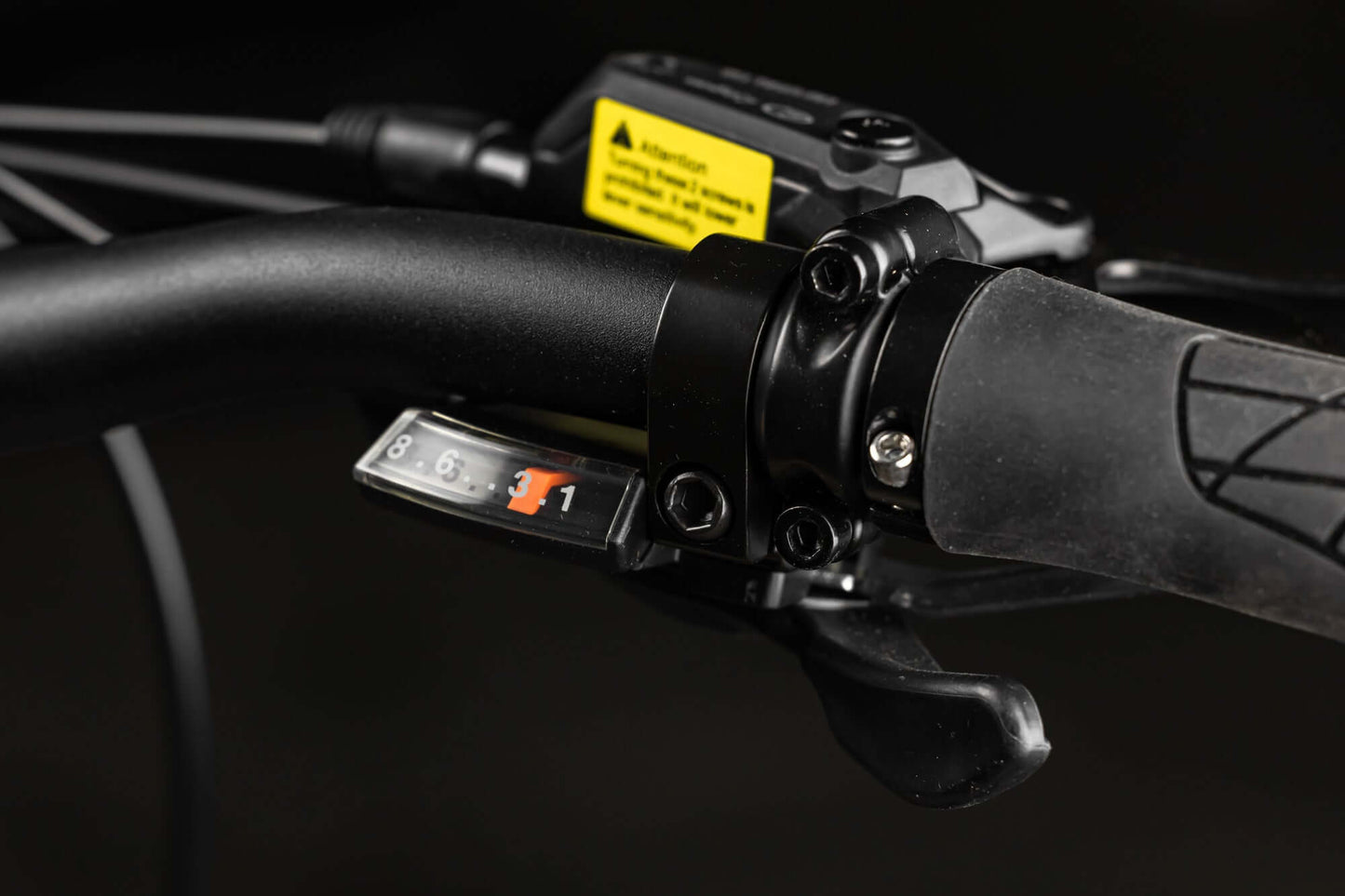 Close-up of Rambo Bikes SAVAGE 2.0 Electric Bikes shifter, brake lever on dark background