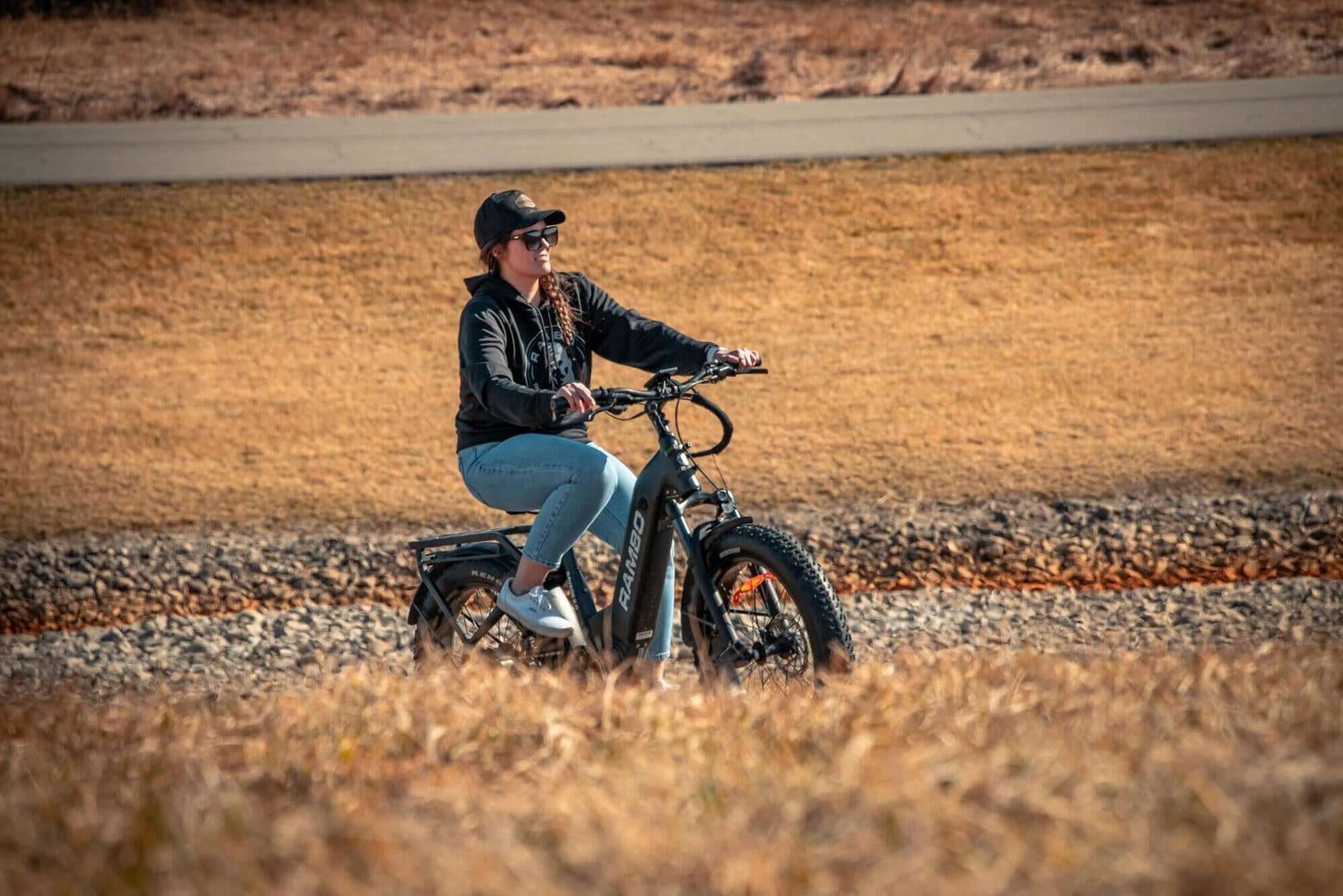 Person riding a Rambo Bikes SAVAGE 2.0 Electric Bike in a desert-like landscape